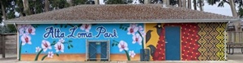 building with mural of flowers birds and woven patterns
